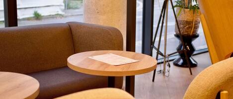 A seating area with a round wooden table and a sofa.