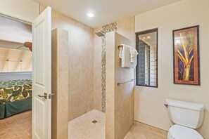 A bathroom with a shower, toilet, and a towel rack. - Fully Renovated Kihei 2BR Condo New AC Tropical Grounds Waterfall Pool (Kihei)