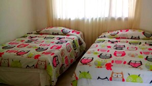 Two twin beds with matching bedding featuring cartoon owls and other animals. - Casa con Piscina Privada Anapoima (Anapoima)