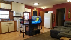 A compact living space with a kitchen, a dining area, and a seating area.