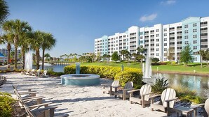 A resort with a pool, lounge chairs, and a large building in the background. - Three Bedroom Deluxe Condo, Orlando, Florida (2194699) (orlando)