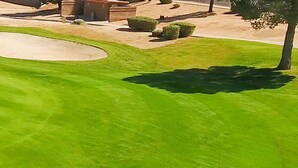 A golf course with a pond, sand bunkers, and a flag on the green. - Le Beau Soleil (Sun City West)