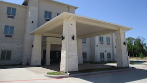 A multi-story building with a covered entrance area, large windows, and a flat roof. - Best Western Plus Chandler (Chandler)