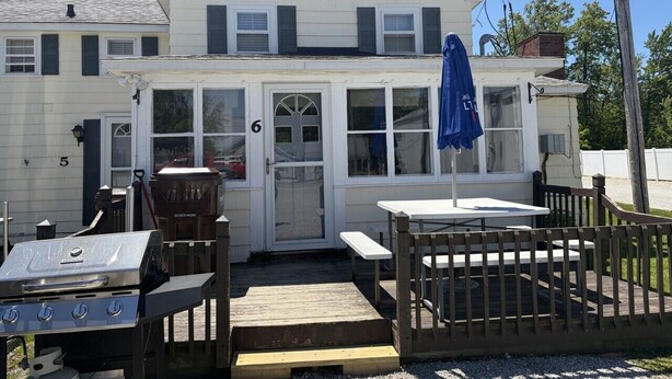 A two-story building with a front porch, a grill, and a table with benches. - Walk to Lake • Strip • Wineries • Firepit (Geneva)