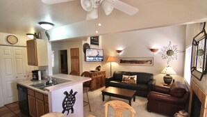 A compact living space with a kitchen, dining area, and a living room. - The Tumbleweed at Solano (Moab)