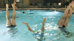 A swimming pool with people in the water. - Moab Oasis Entire Condo (Moab)