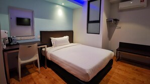 A hotel room with a bed, desk, chair, and a television mounted on the wall. - D'green Hotel Kuching (Kuching)