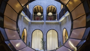 Ein Rundblick in den Innenraum eines Gebäudes mit Bogenfenstern und einem Balkon.