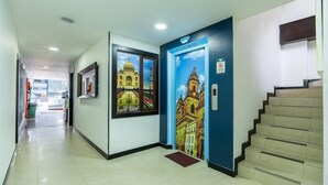 A hallway with a staircase leading to a blue door labeled "CATHEDRAL". - Hotel Budhha Resort (Bogotá)
