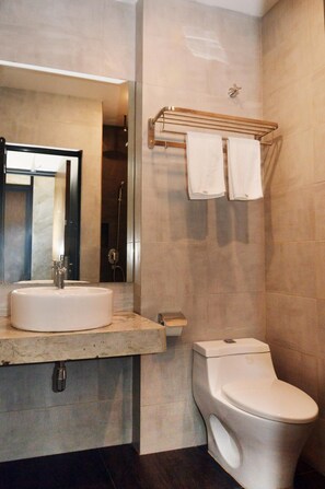 A modern bathroom with a sink, toilet, and a towel rack. - De Luna Hotel Sri Petaling (Kuala Lumpur)