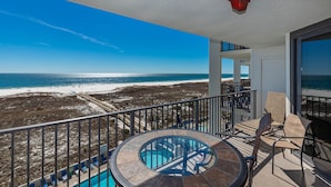 A balcony with a pool, chairs, and a view of the beach and ocean. - Coastal Comfort with Gulffront Charm Phoenix VI 6510 (Orange Beach)