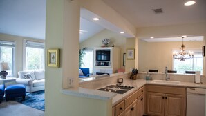 A modern kitchen with a built-in oven, a sink, and wooden cabinets. - Private Home with SPA and Private pool, Beautiful Lagoon views (Hilton Head Island)
