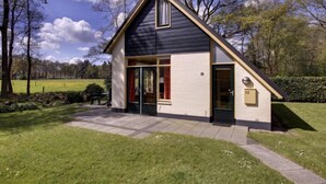A modern house with a sloped roof, large windows, and a door with a number plaque. - Buitenplaats Gerner by Interhome (Dalfsen)