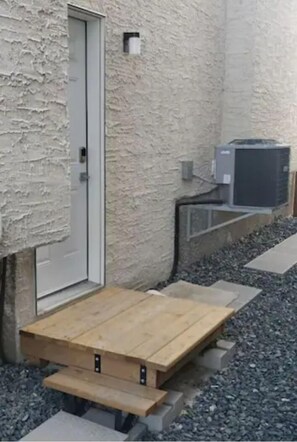 Relax on a bench in this serene outdoor space, featuring a gravel ground and stepping stones.