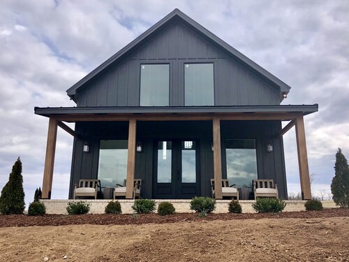 Cottage with panoramic hilltop views and stocked pond on 80 acres. 