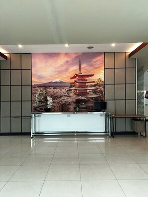 A reception desk with a backdrop of a traditional Japanese pagoda and cherry blossoms. - Hotel Sogo Mindanao Ave. (Quezon City)