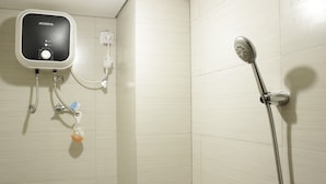 A bathroom with a shower, a wall-mounted water heater, and a towel rack. - Spacious Studio Room at Gateway Pasteur Apartment near Exit Toll Pasteur (Cimahi)