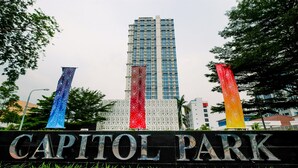 A sign for Capitol Park with a tall building in the background. - Best Location and New Furnished @ Studio Capitol Park Residence Apartment (Jakarta)