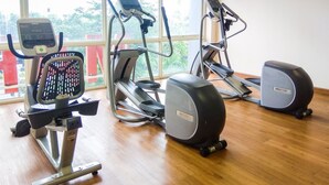 A gym with cardio machines, a rowing machine, and a stationary bike.