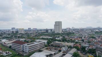 A cityscape with a prominent high-rise building, various smaller buildings, and a mix of residential and commercial structures.