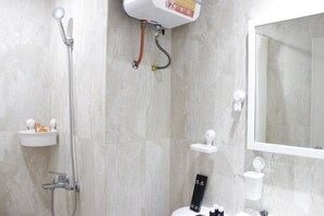 A bathroom with a shower, sink, and toilet.