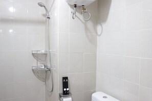 A modern bathroom with a shower, toilet, and a soap dispenser on the wall. - Fabolous Thematic 2BR Apartment at Parahyangan Residence Near UNPAR (Bandung)