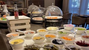 A buffet setup with various food items and condiments. - Residence Inn by Marriott Algiers Bab Ezzouar (Algiers)