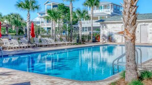 A swimming pool with lounge chairs and palm trees. - Reba’s Retreat – A Charming Seacrest Beach Escape (Seacrest)