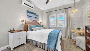 A bedroom with a bed, a dresser, a desk, a ceiling fan, and a window with curtains. - Reba’s Retreat – A Charming Seacrest Beach Escape (Seacrest)