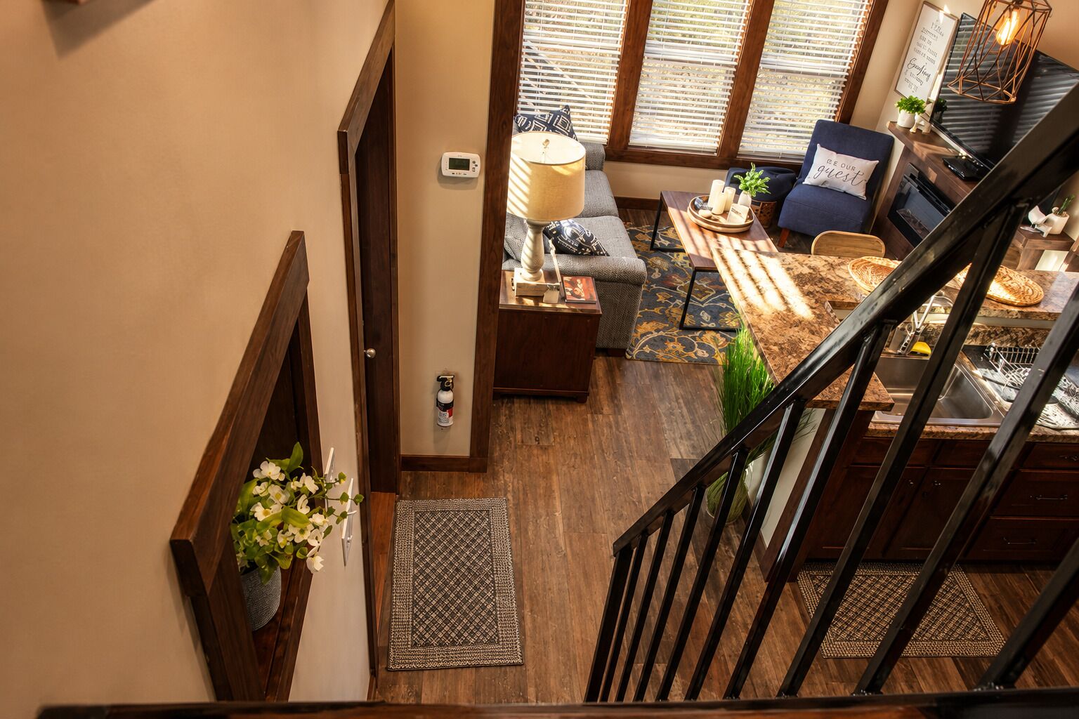 A staircase leading to a living area with a sofa, a lamp, and a coffee table.