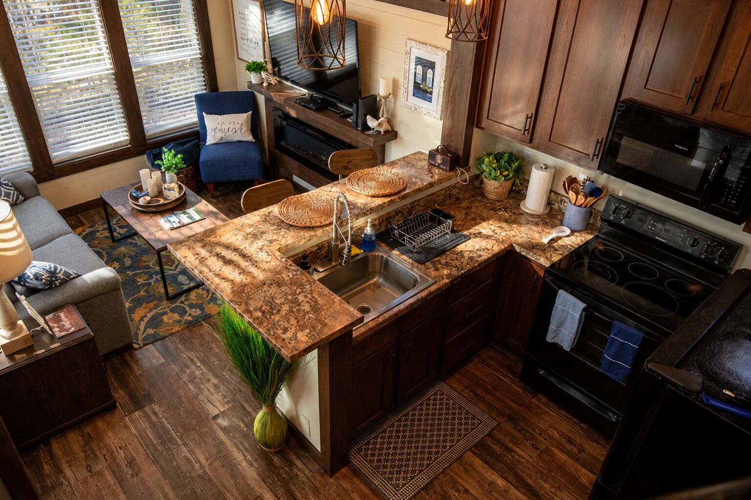 A modern kitchen with a large island, built-in appliances, and a cozy seating area.