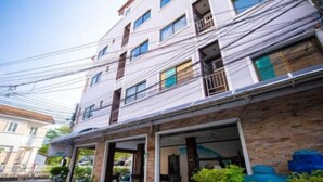 A multi-story building with a brick facade and multiple balconies. - Phuket Paradise Hotel (Patong)