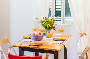 Enjoy a meal for two in this cozy dining area with a table set for a romantic breakfast.
