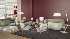 A modern living room with a sofa, chairs, a coffee table, and a lamp. - OKKO Hotels Lille Centre (Lille)