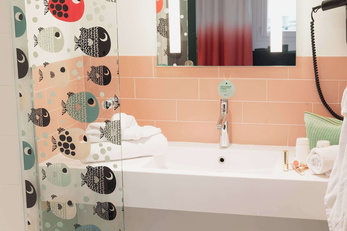 A bathroom with a sink, a mirror, and a towel rack.
