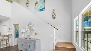 A staircase with wooden steps leading to a landing. - Spacious family fun with game room, only 4 miles from East Beach! Relax + Enoy! (St. Simons Island)