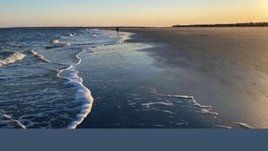 A beach with waves gently lapping onto the shore. - Spacious family fun with game room, only 4 miles from East Beach! Relax + Enoy! (St. Simons Island)