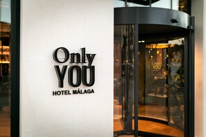 A hotel entrance with a revolving door and a sign that reads "Only You HOTEL MÁLAGA". - Only YOU Hotel Malaga (Málaga)