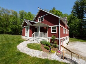 A two-story red house with a white porch and a gravel driveway. - Peaceful, Post and Beam Loft, Sleeps 9 (New Marlborough)