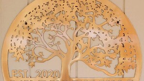 A circular wooden sign with a tree design and the text "EST. 2020 THE BIRDHOUSE". - The Bird House near Zion & Bryce  (Kanab)
