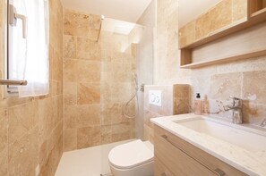 Shower, hair dryer, towels, shampoo