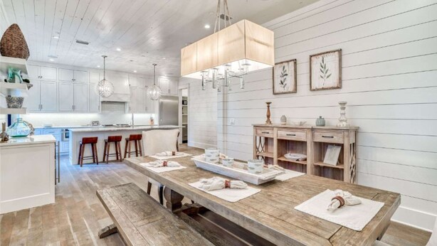 A modern kitchen with white cabinetry, a wooden island, and pendant lighting. - h2o365-The Heart of Seagrove (Santa Rosa Beach)