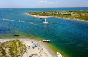 A coastal area with boats, a beach, and a lighthouse. - 5-Mins to Forest Beach Dog Friendly! (Chatham)