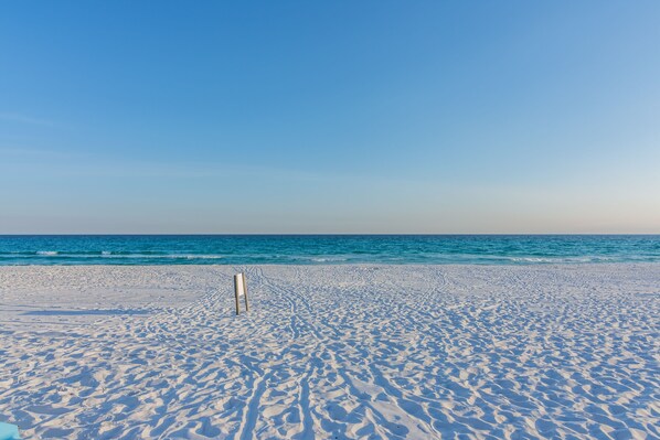 A beach with a clear sky and ocean.