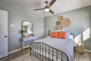 A bedroom with a bed, a ceiling fan, a dresser, a mirror, and wall decor. - 7 Mi to Keystone: Mtn-View Abode w/ Deck! (Dillon)