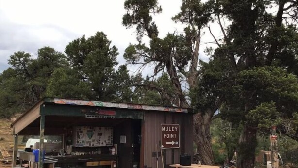 A rustic outdoor café with a sign reading "Muley Point". - While not a hotel, the Feather Trailer provides a relaxed, peaceful retreat in nature with the warmth and convenience you need for a memorable outdoor getaway. (Monticello)