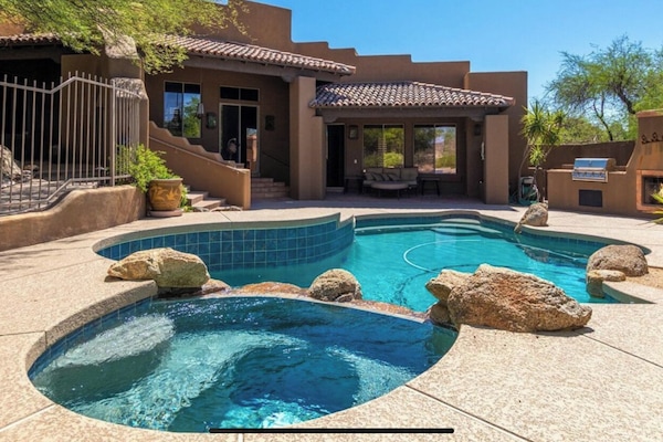 Resort style yard with built in grill and lunge area