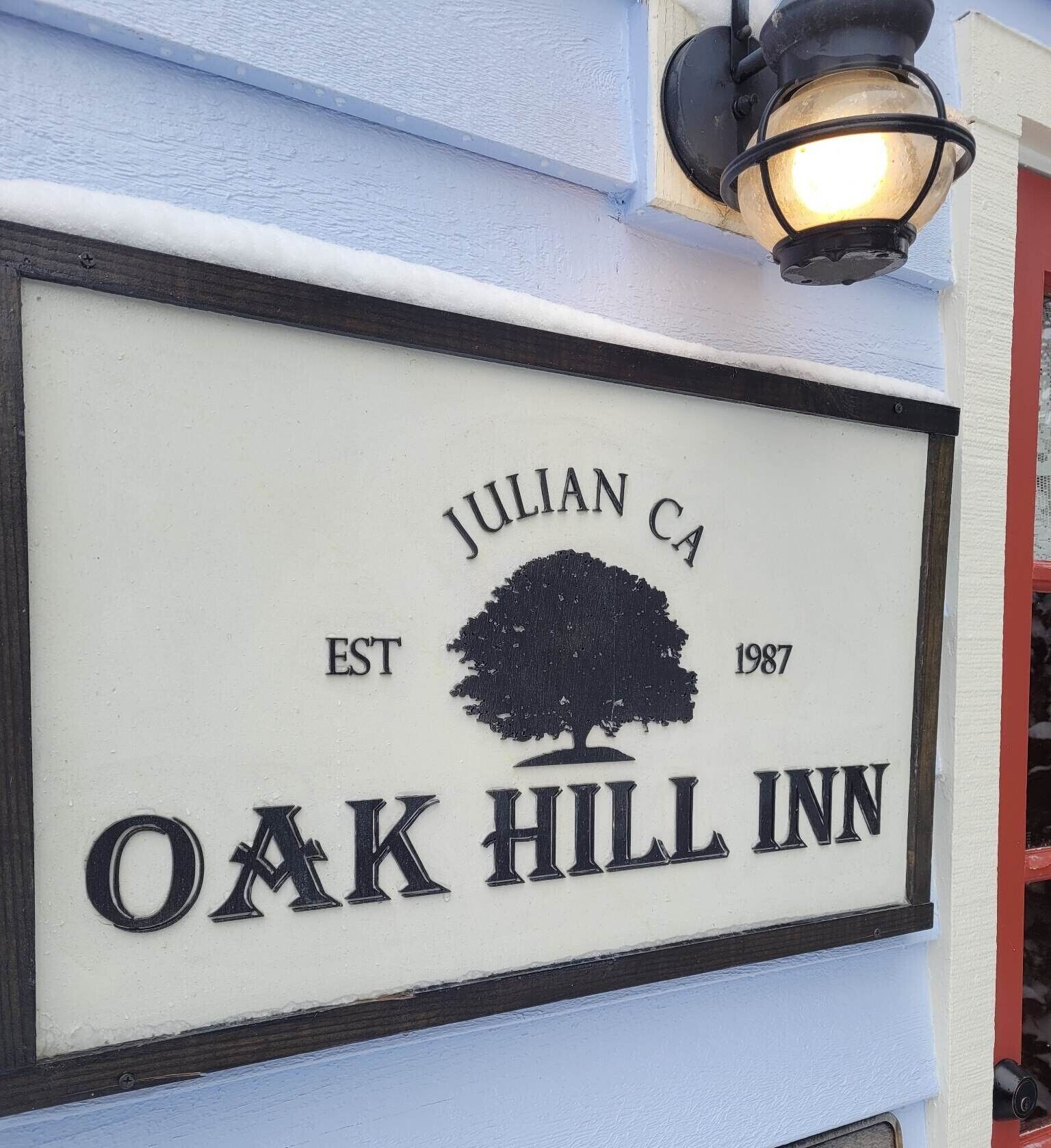 A sign for Oak Hill Inn with the text "Julian CA EST 1987".