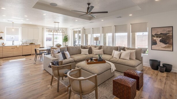A spacious living room with a sectional sofa, a dining area, and a kitchen in the background. - Destination Ledges Utah (St. George)
