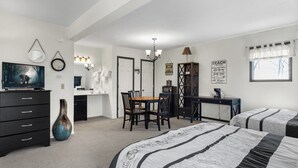 A bedroom with two beds, a desk, a chair, a dresser, a TV, and a mirror. - Anchors Away - Three Bedroom House, Sleeps 12 (Osage Beach)